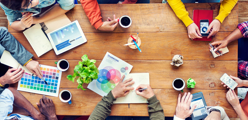 People sitting around a table designing