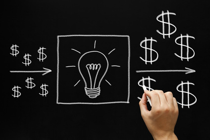 Hand drawing investment concept with white chalk on blackboard
