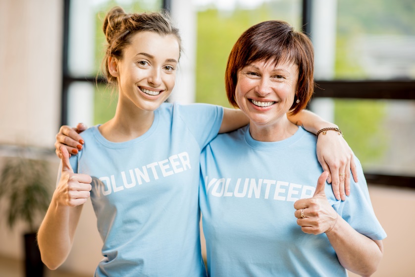 volunteer women giving thumbs up