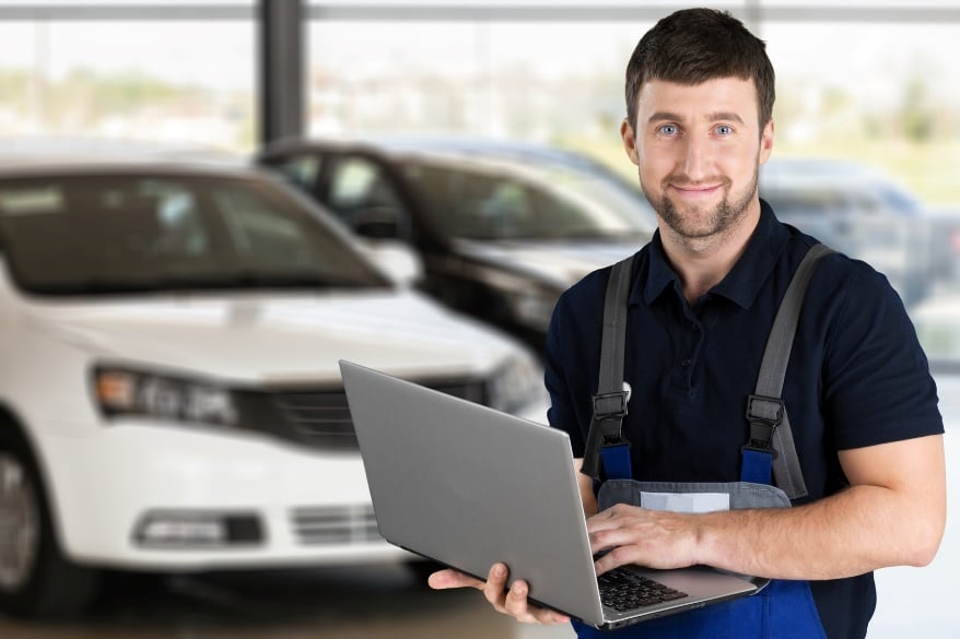auto repair worker on laptop